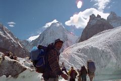 03 Porter Muhammad Khan Crossing A Small River On The Upper Baltoro Glacier With Gasherbrum IV Behind.jpg